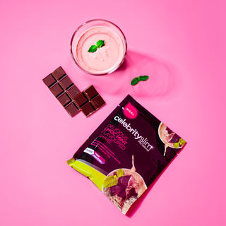 Celebrity Slim Choc Mint with a glass of Celebrity Slim Choc Mint and two pieces of chocolate and mint leaves