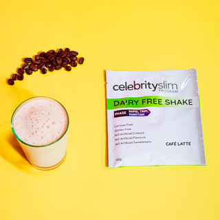 Celebrity Slim Dairy Free Cafe Latte sachet with a glass of Celebrity Slim Dairy Free Cafe Latte and coffee beans
