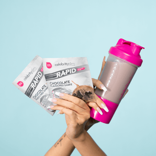 A woman holding up two sachets of Celebrity Slim Rapid Chocolate and a Celebrity Slim Shaker