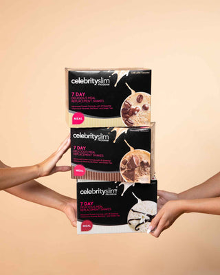 Boxes of Celebrity Slim 7 Day Delicious Meal Replacement Shake Cafe Latte, Chocolate, and Vanilla stacked atop each other